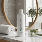 Misumi Clear Skin Salicylic Cleanser 120ml bottle on marble countertop with rolled white towel, green soap, and jade roller, highlighting skincare routine and acne-prone skin care
